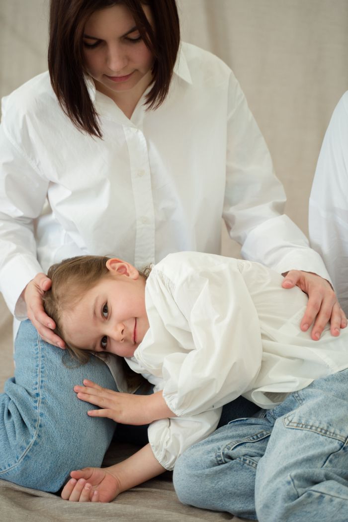 Capture of a tender moment between a mother and child sharing a warm embrace indoors.